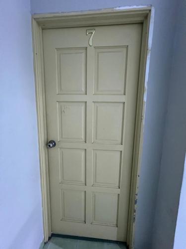 a white door with a hook on it in a room at Muhibbah Homestay 1 in Port Dickson