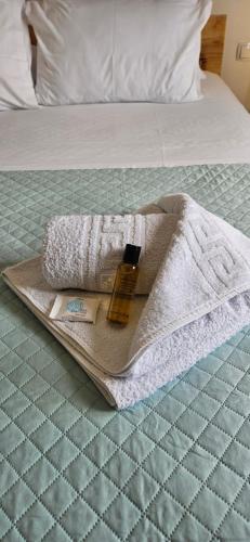 a towel and a bottle on a tray on a bed at heaven suite elafonisi in Elafonisi