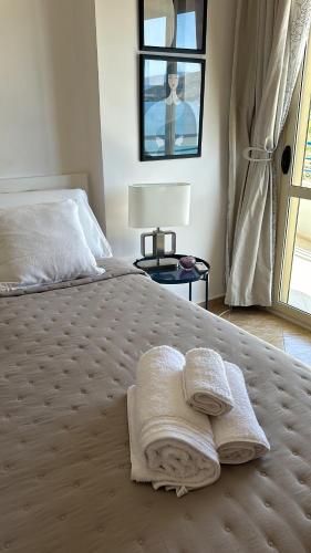 a bedroom with a bed with two towels on it at Casa con vista mare in Vlorë
