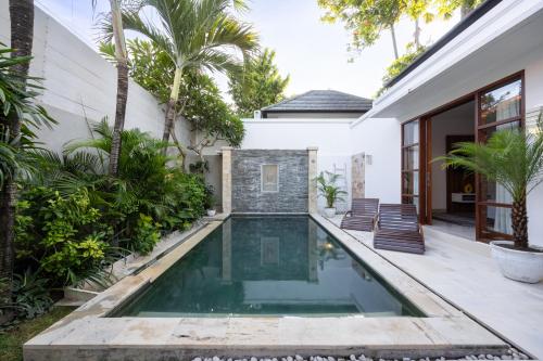 a swimming pool in the backyard of a house at Villa Manis La Bora in Seminyak in Seminyak