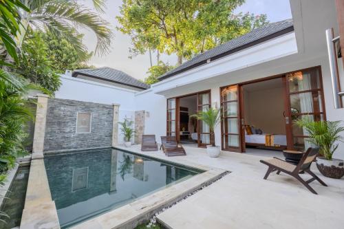 an external view of a villa with a swimming pool at Villa Manis La Bora in Seminyak in Seminyak