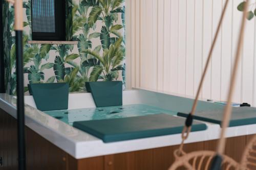 a glass counter top with three potted plants on it at Emesh Boutique Suite in Agrigento