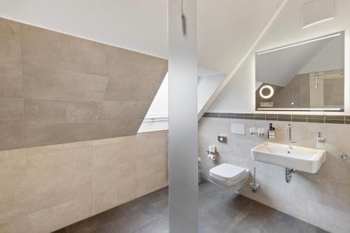 a bathroom with a sink and a toilet at Amelie chez Inez in Radolfzell am Bodensee