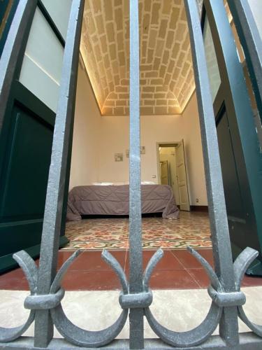 a view of a bedroom through a iron gate at L'isola Felice in Trapani