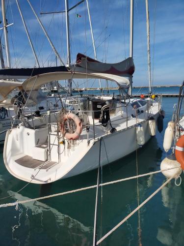 a sailboat is docked in the water at Islablanca in Bari