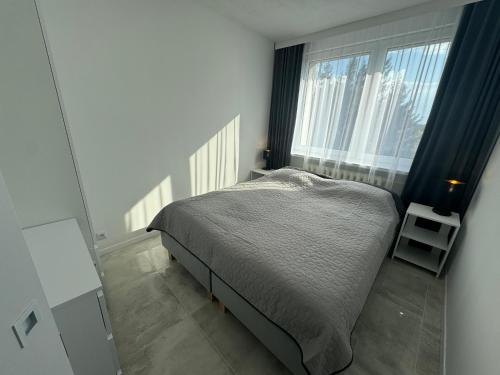 Postel nebo postele na pokoji v ubytování Apartament Słoneczny
