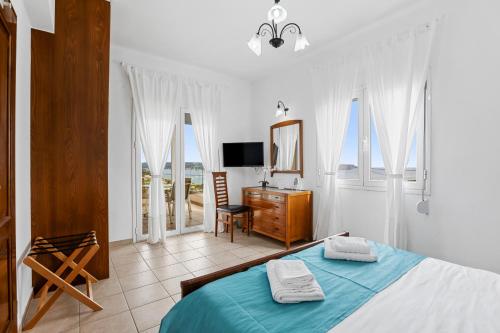 カリヴェスにあるSea view villa Manolis with private pool near the beachのベッドルーム(ベッド1台、デスク、テレビ付)
