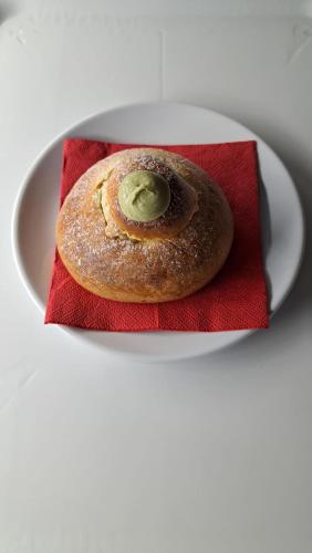 a pastry sitting on a plate with a red napkin at La Foggia seaside paradise in Siculiana