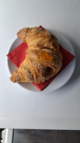 a white plate with a pastry on a red napkin at La Foggia seaside paradise in Siculiana