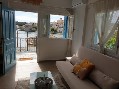 a living room with a couch and a view of the water at Galaxa Mansion in Galaxidhion