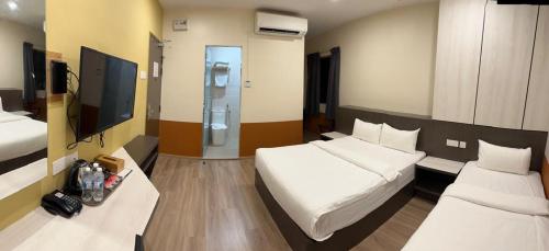 Postel nebo postele na pokoji v ubytování T SQUARE HOTEL (IPOH)