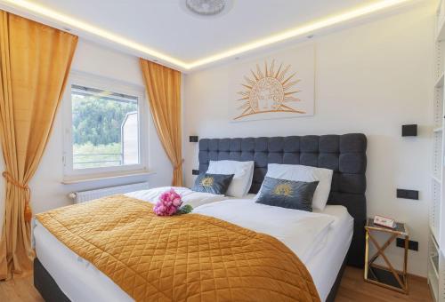 a bedroom with a large bed and a window at CT-GOLD Penthouse Bodensdorf Amatera privater Seezugang Hallenbad, Skiarena Gerlitzen in Bodensdorf