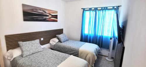 Postel nebo postele na pokoji v ubytování Arinaga Beach Gran Canaria