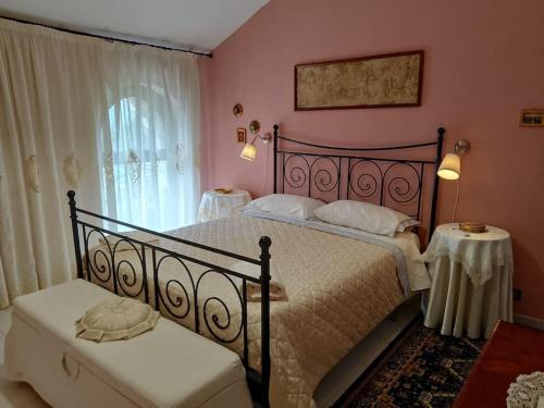 a bedroom with a large bed and two tables at Villa Elvira in Pellezzano