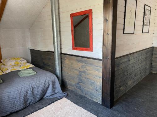 a bedroom with a bed with a red window at Villa Aronia in Porvoo