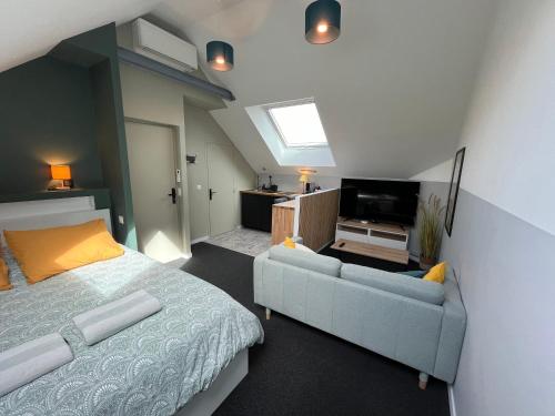 1 dormitorio con cama, sofá y TV en Chambres privées proche DISNEY Parcs, en Chanteloup-en-Brie