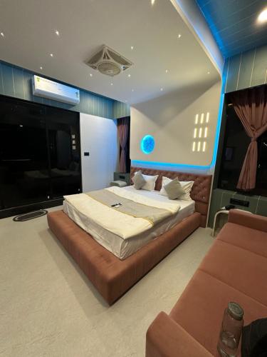 a bedroom with a large bed and a flat screen tv at Hotel victoria prime in Surat