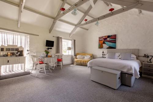 a bedroom with a bed and a living room at Chypons Farm Bed & Breakfast in Penzance