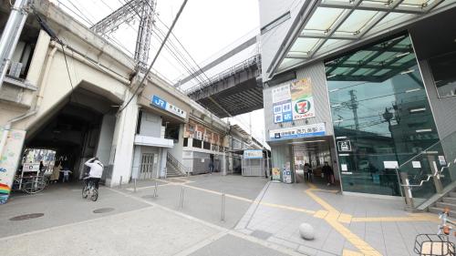 a person riding a bike inside of a building at Ayanishiki大阪西九条STAY in Osaka