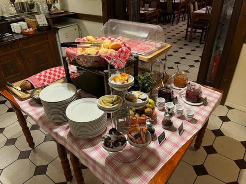 a table with plates and bowls of food on it at Hotel American in Venlo