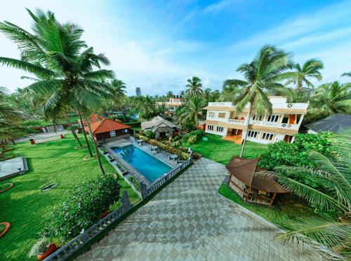 an aerial view of a resort with a swimming pool at Asokam Beach Resort in Kannur
