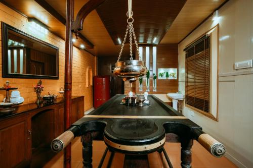 a dining room with a table in a room at Asokam Beach Resort in Kannur