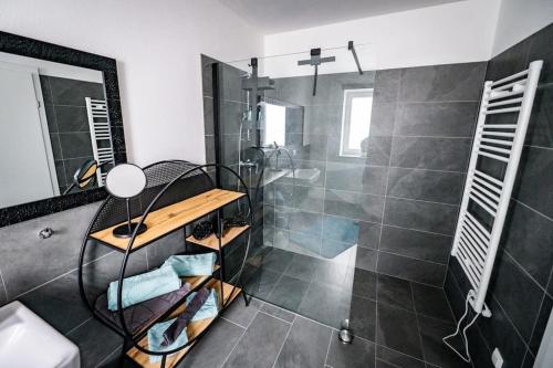 a bathroom with a shower and a walk in shower at Schicke Wohnung in Seenähe! 