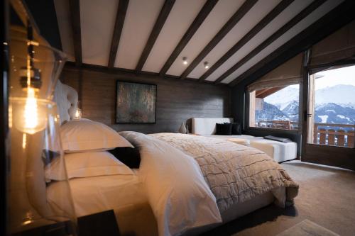 a bedroom with a bed with a view of a mountain at No 14 Verbier in Verbier