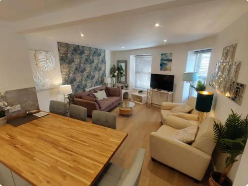 a living room with a table and a couch at No 1A Penlee in Penzance