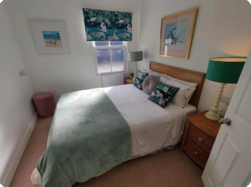 a bedroom with a large bed and a window at No 1A Penlee in Penzance