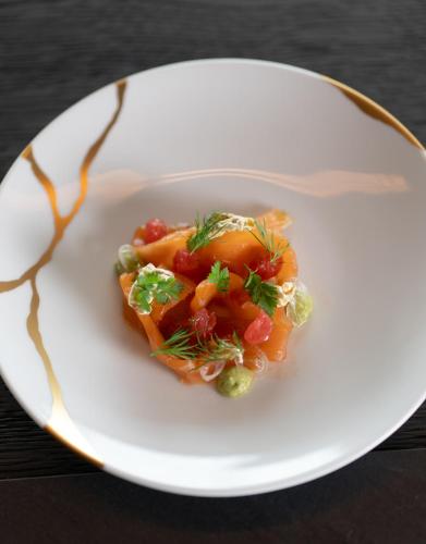 a white plate with a dish of food on a table at No 14 Verbier in Verbier