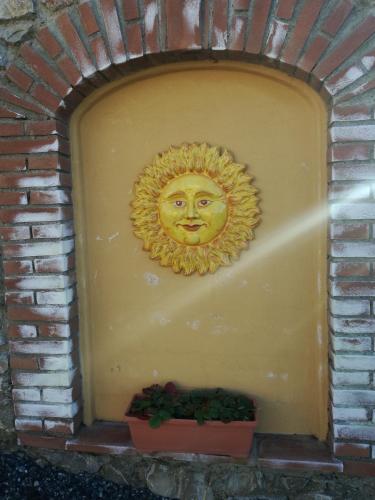 a gold mask on a wall with a plant at Cintoia, Tuscany Beautiful villa with private pool in Santa Luce