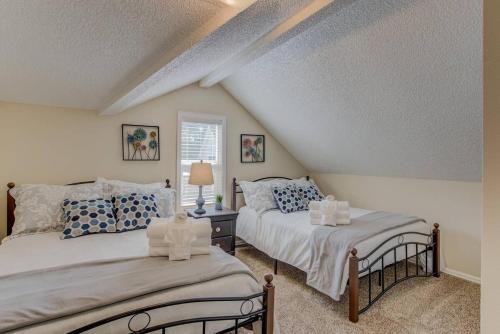 a bedroom with two beds in a attic at 3BR DOWNTOWN - NEW Hot Tub - Olympic Training Center in Colorado Springs