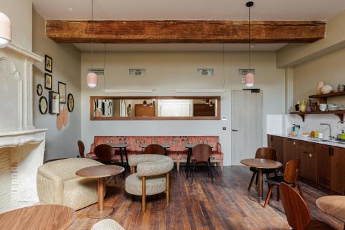 - un restaurant avec des tables et des chaises dans une salle dans l'établissement La Loge Gogaille - Cloître - Accès autonome, à Orléans