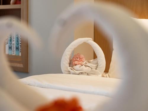 a small white crib with a flower in a towel at Saigon Aroma Hotel in Hanoi