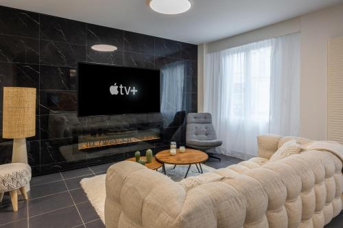 a living room with a large couch and a fireplace at News ! Loft Movie Station Champagne in Reims