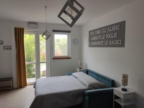a bedroom with a bed and a couch and a window at Casa Vacanza Mattirolo - Castagneto Po in Castagneto Po