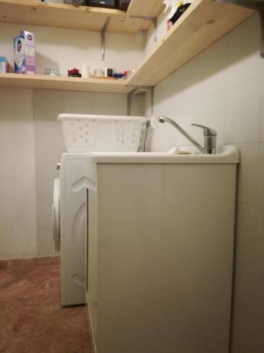 a kitchen with a sink and a washing machine at Cintoia, Tuscany Beautiful villa with private pool in Santa Luce
