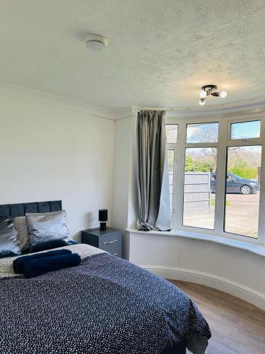 um quarto com uma cama e uma janela em Deluxe Bungalow em Longham