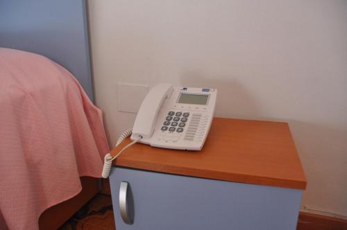 a phone is sitting on top of a desk at Hotel Le Pelagie in Lampedusa