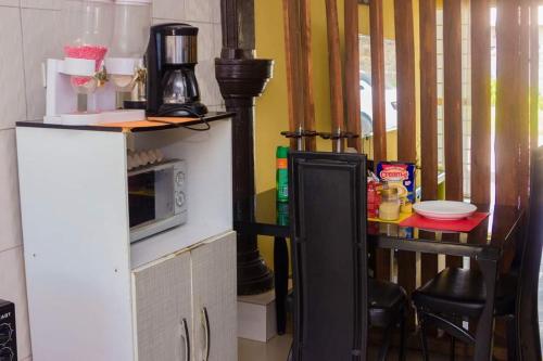 a kitchen with a counter with a microwave and a table at Itawa Apartments in Ndola