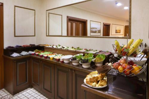 a buffet line with fruits and vegetables in a hotel room at Bender Hotel in Istanbul