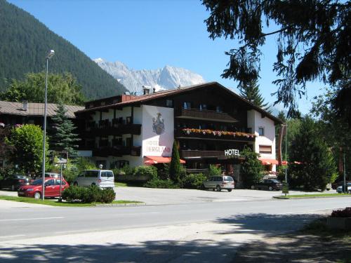 a building on the side of a street with a mountain at Landhaus "das MOOSWALD" in Obsteig