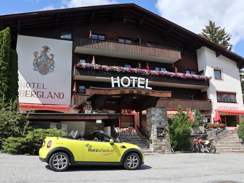 a yellow car parked in front of a hotel at das MOOSWALD in Obsteig