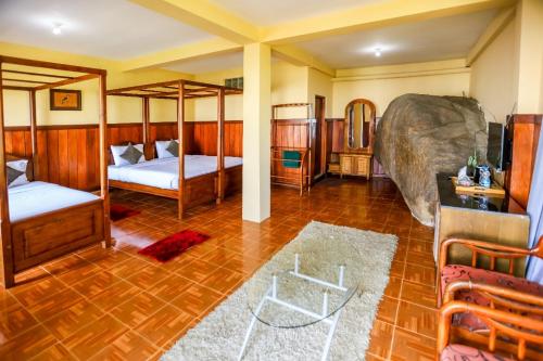 a room with two bunk beds and a couch at Srilak View Holiday Inn in Haputale