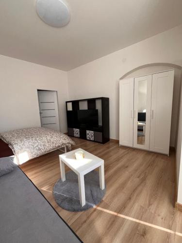 a bedroom with a bed and a table and a tv at Ubytování v podzámčí in Úsov