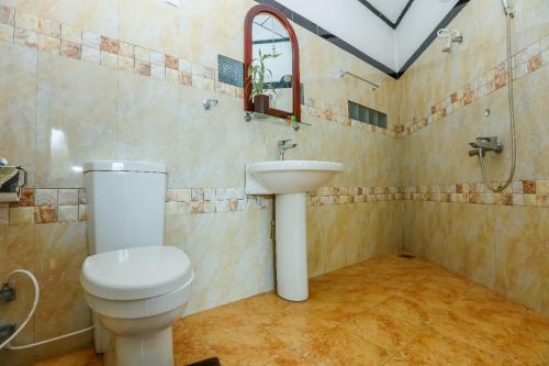 a bathroom with a toilet and a sink at Srilak View Holiday Inn in Haputale