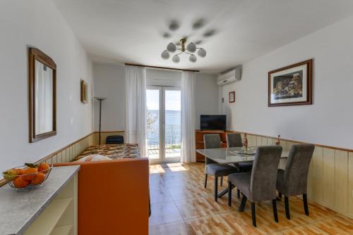 a kitchen and dining room with a table and chairs at Villa Fontana in Starigrad-Paklenica