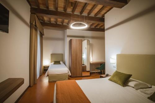 Postel nebo postele na pokoji v ubytování Hotel Villa Montegranelli