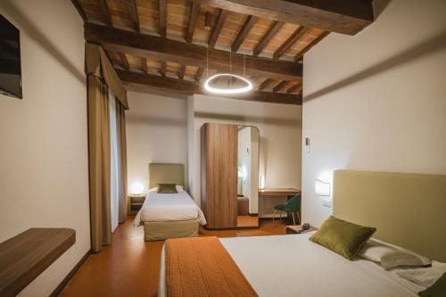 Postel nebo postele na pokoji v ubytování Hotel Villa Montegranelli